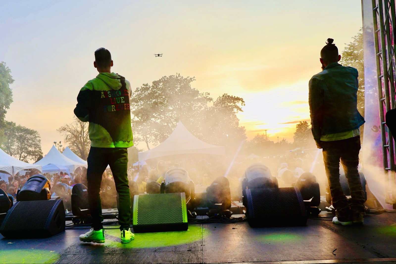 KING T and LUSS performing on a festival stage at sunset