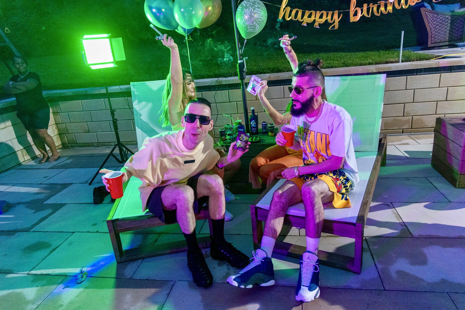 KING T and LUSS at a party in green light