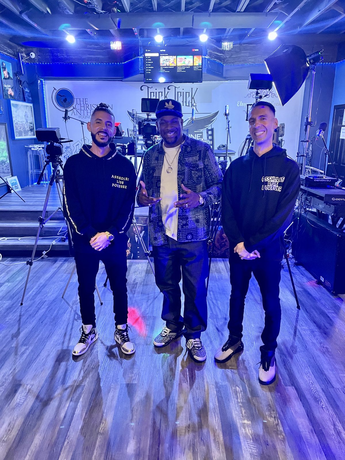 KING T and LUSS with two artists on a stage lit in blue