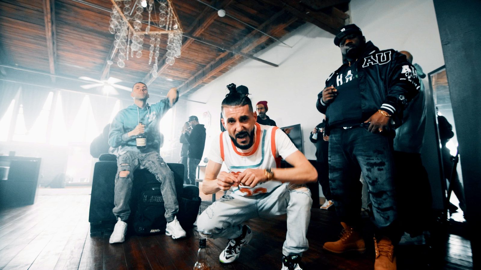KING T and LUSS with the crew in a music video still
