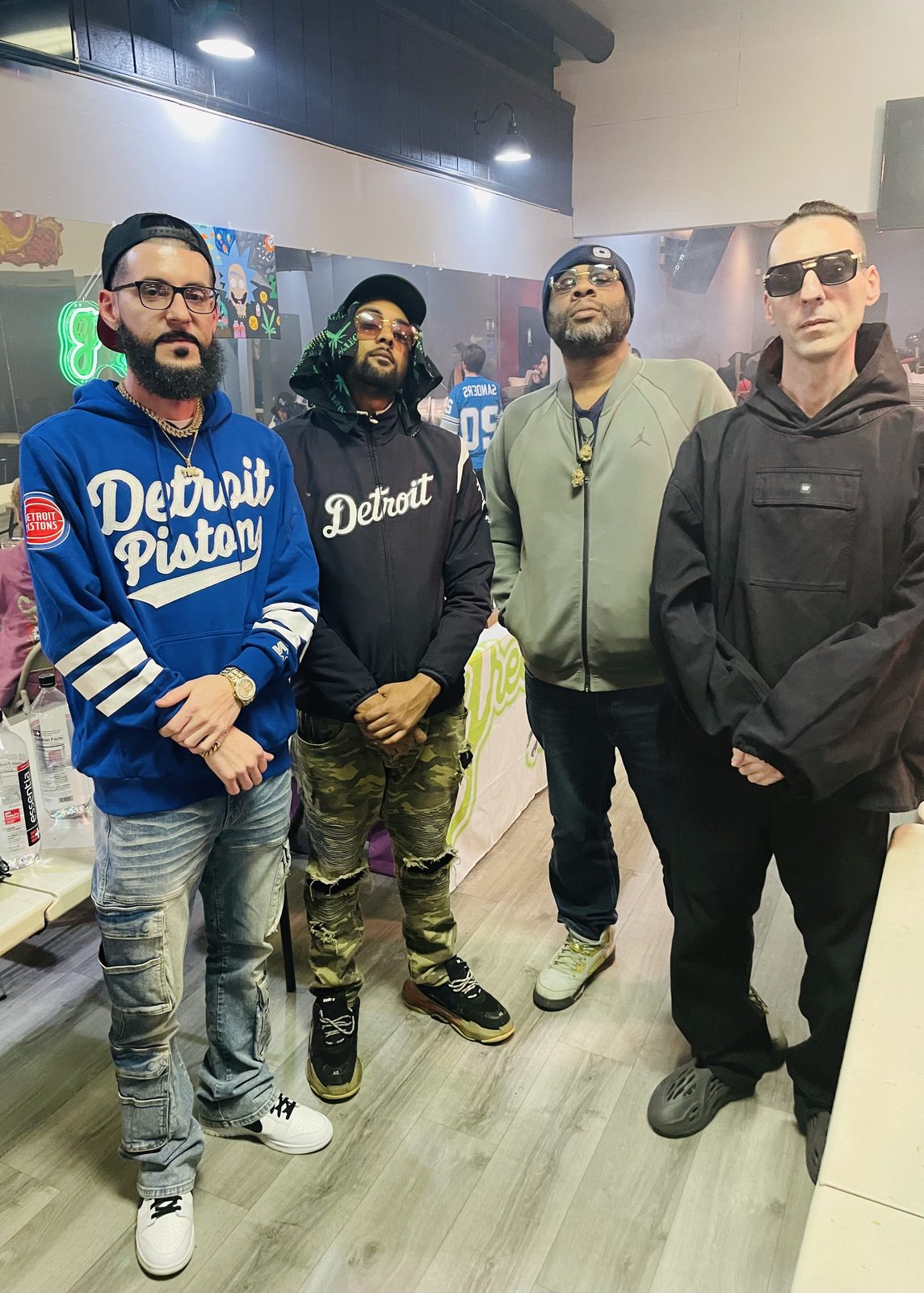 Four people, with LUSS in a Detroit Pistons hoodie