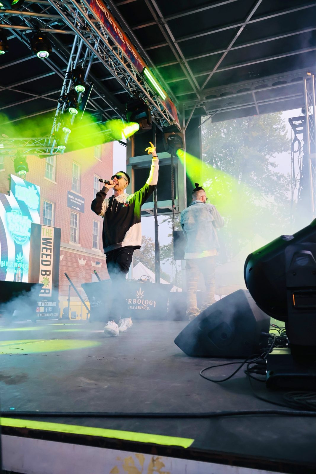 Performing on stage in green smoke
