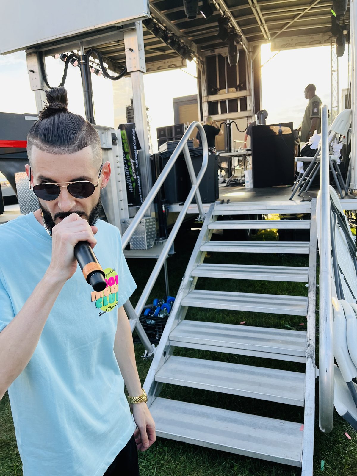 LUSS with a mic by the stage stairs