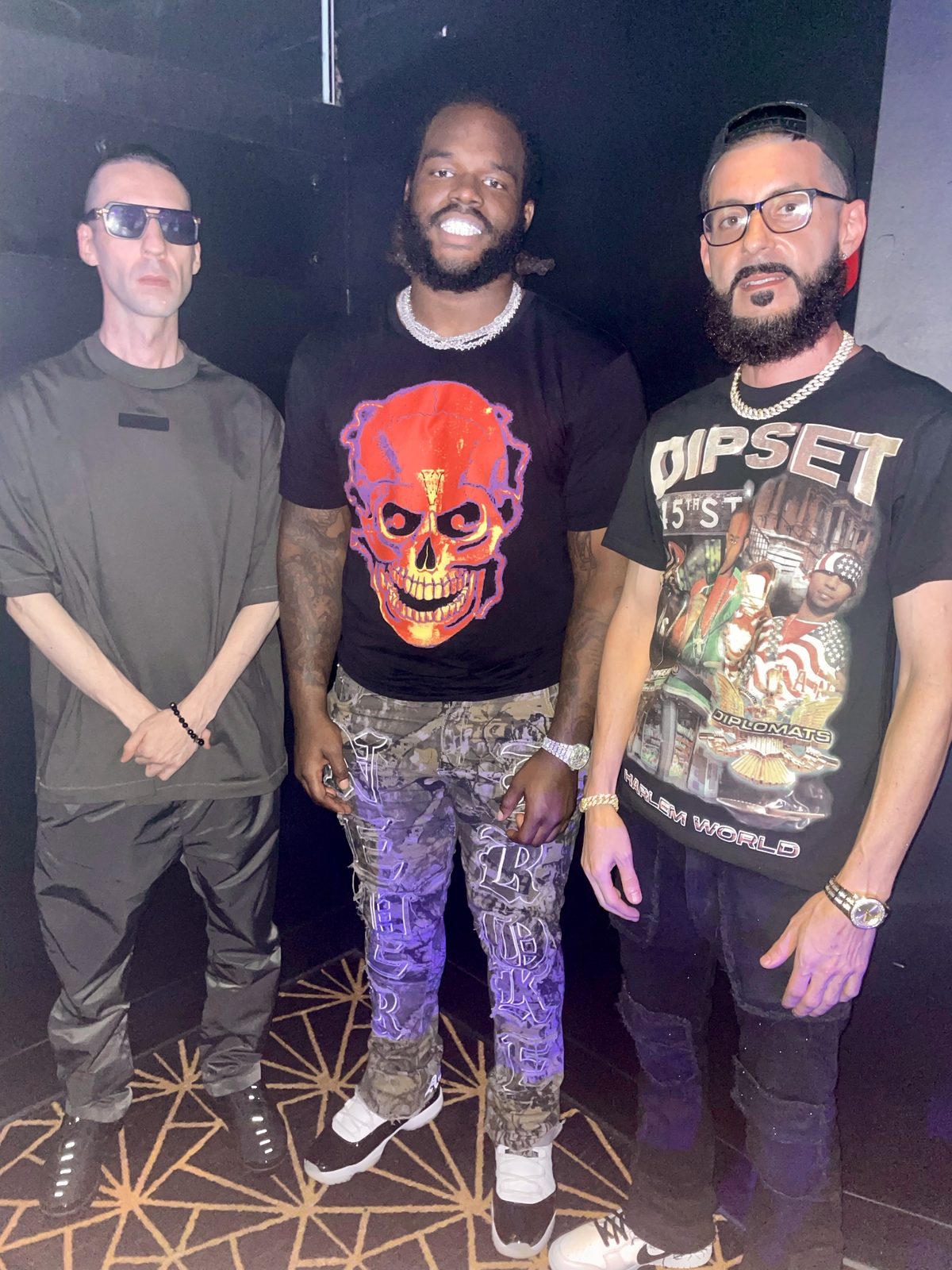 Three people at a dark venue