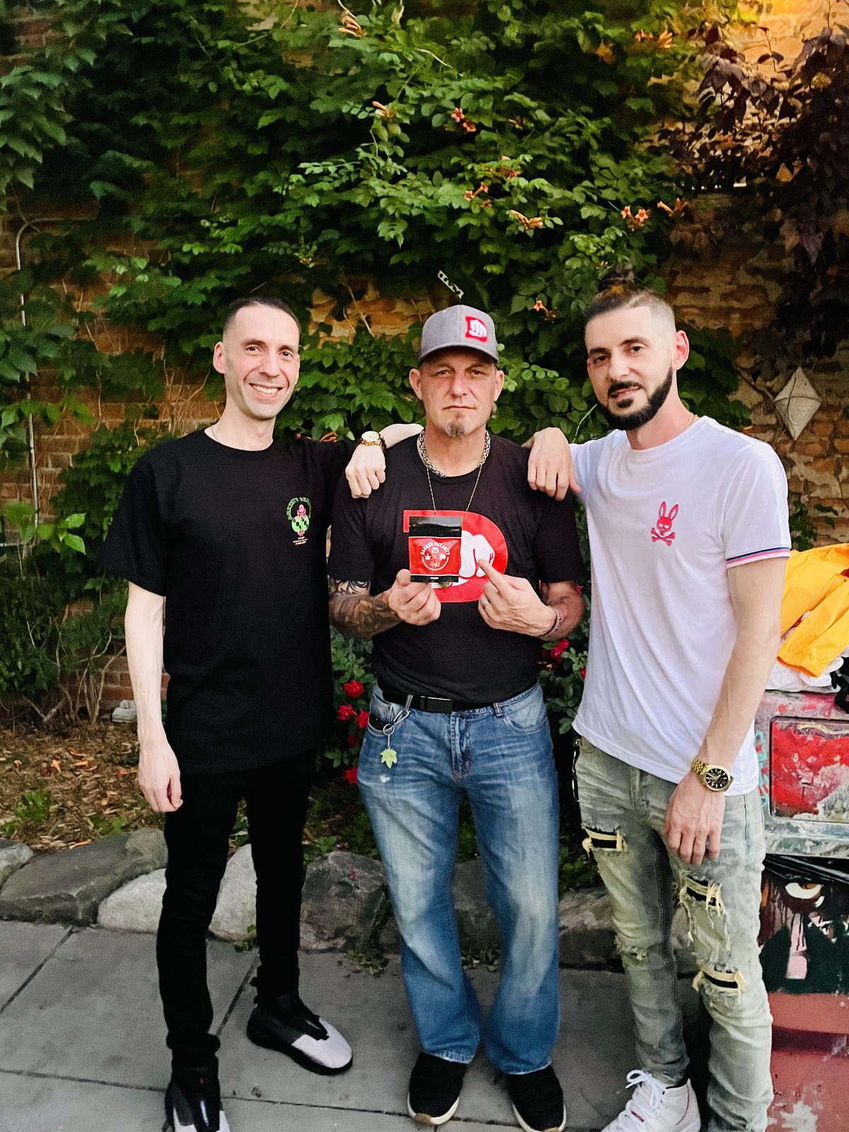 KING T and LUSS with a fellow artist in front of trees